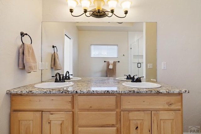 full bath with a stall shower, a sink, and double vanity