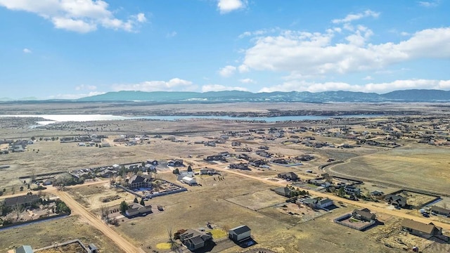 aerial view featuring a water and mountain view