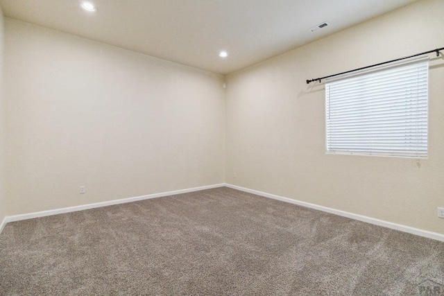 carpeted empty room featuring recessed lighting, visible vents, and baseboards