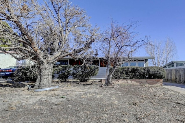 view of front of house featuring fence