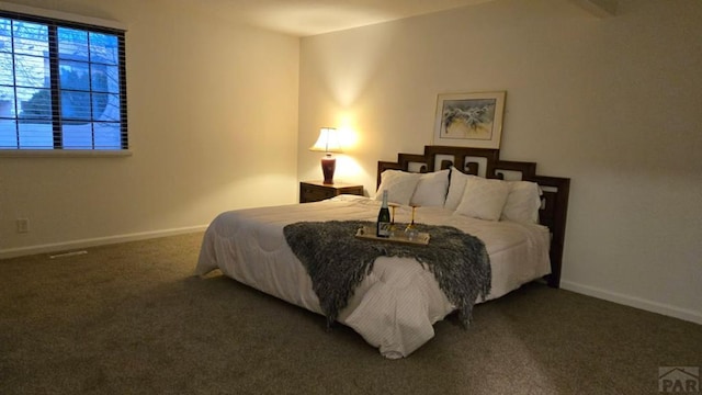 bedroom featuring dark colored carpet and baseboards