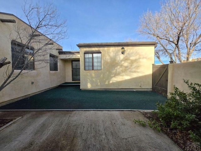 exterior space featuring fence and stucco siding