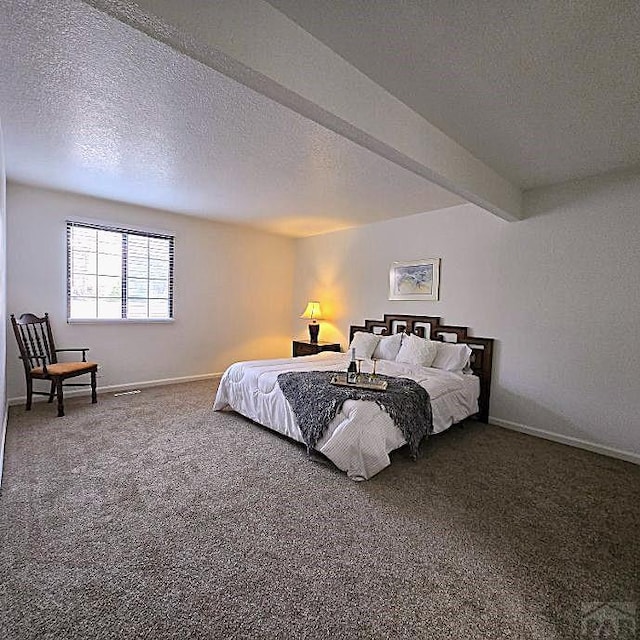 bedroom featuring carpet, beam ceiling, a textured ceiling, and baseboards