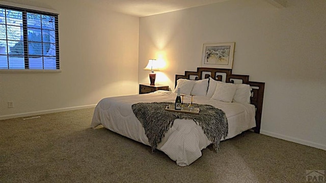 carpeted bedroom with baseboards