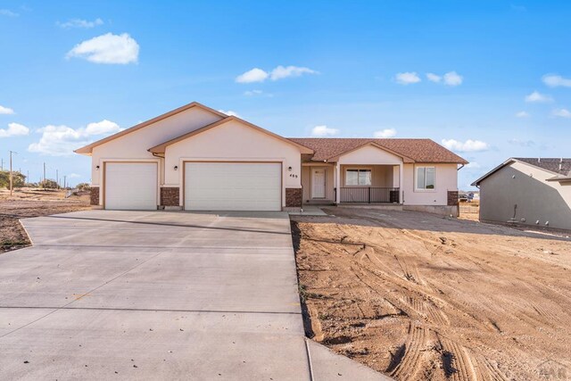 single story home with a garage, concrete driveway, and stucco siding