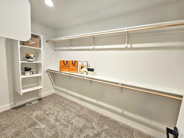 walk in closet featuring carpet flooring and visible vents