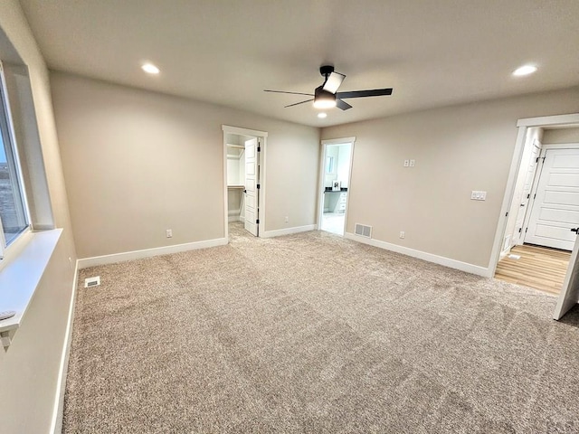 spare room with recessed lighting, visible vents, light carpet, and baseboards