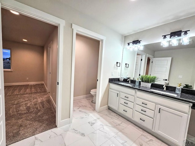 full bath with a sink, baseboards, and marble finish floor