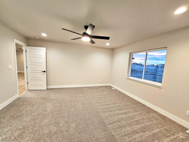 carpeted empty room featuring a ceiling fan, recessed lighting, and baseboards