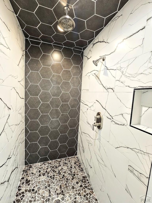 bathroom with tiled shower