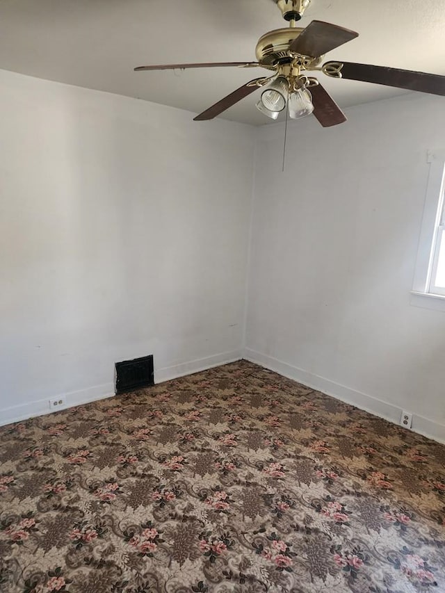 carpeted empty room featuring baseboards