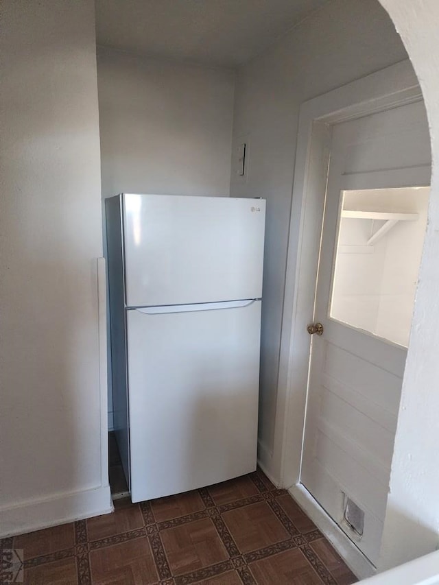 kitchen with freestanding refrigerator