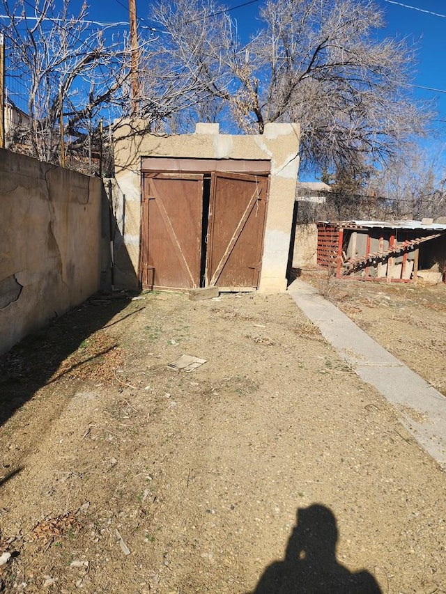 view of shed with fence