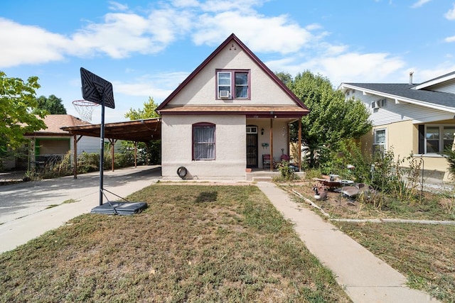 view of front of house with concrete driveway, covered porch, a front yard, a carport, and stucco siding