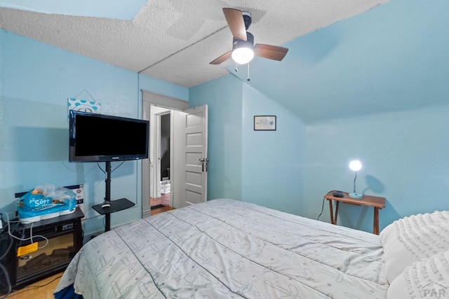 bedroom featuring a textured ceiling and a ceiling fan