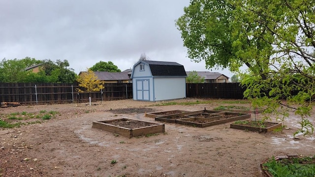 270 W Baldwyn Dr, Pueblo West, CO 81007 - fenced backyard featuring a vegetable garden, a storage unit, and an outdoor structure