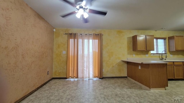270 W Baldwyn Dr, Pueblo West, CO 81007 - kitchen with ceiling fan, a peninsula, baseboards, and light countertops