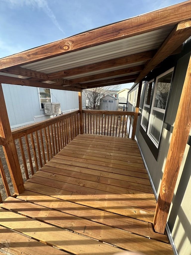 wooden terrace with a shed