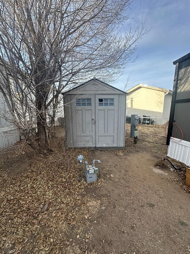 view of shed featuring fence