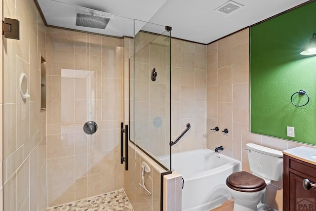 bathroom featuring a stall shower, visible vents, toilet, vanity, and a bath