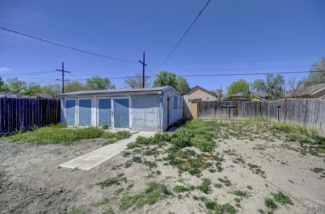 exterior space featuring an outbuilding and a fenced backyard