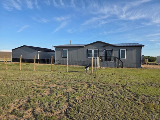 256 E First St, Hasty, CO 81044 - view of front of property featuring fence, a front yard, and metal roof