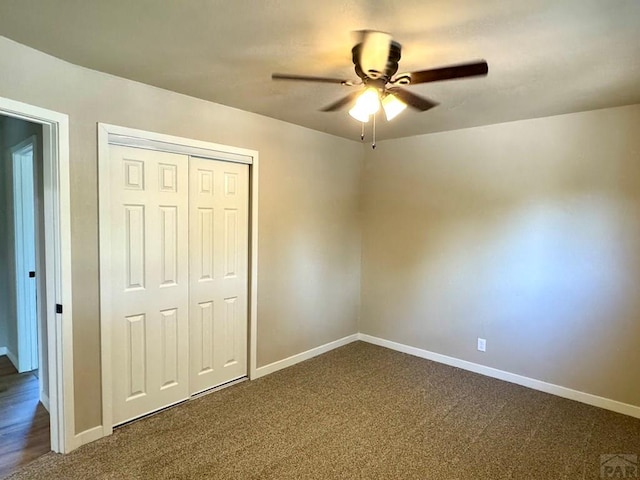 3923 Lancaster Dr, Pueblo, CO 81005 - unfurnished bedroom featuring dark colored carpet, a closet, and a ceiling fan