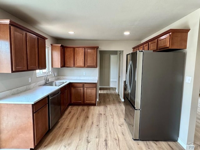 3923 Lancaster Dr, Pueblo, CO 81005 - kitchen with appliances with stainless steel finishes, light wood-style flooring, light countertops, brown cabinets, and recessed lighting