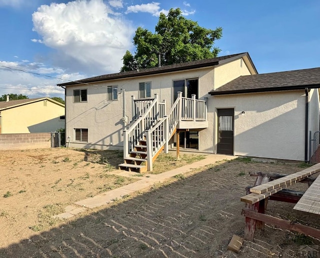 3923 Lancaster Dr, Pueblo, CO 81005 - back of house featuring stucco siding, stairway, and a deck
