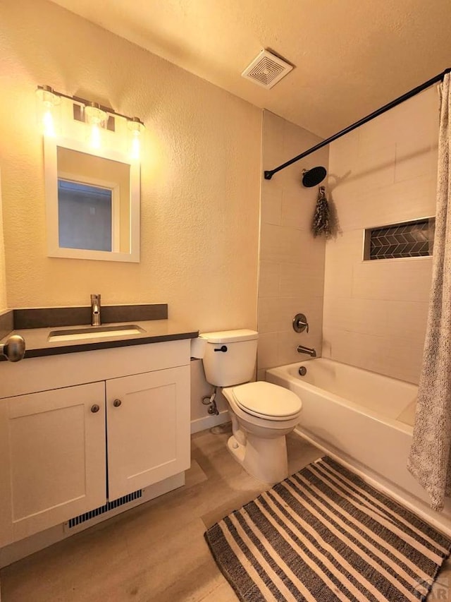 bathroom with toilet, visible vents, shower / tub combo with curtain, and vanity