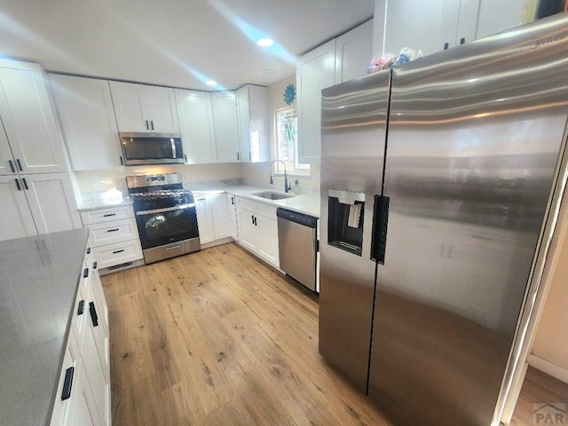 kitchen featuring white cabinetry, appliances with stainless steel finishes, and a sink