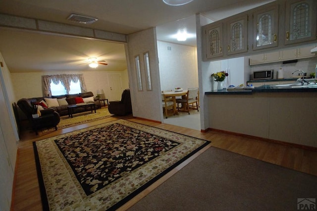 358 13th St, Penrose, CO 81240 - living area featuring wood finished floors and a ceiling fan