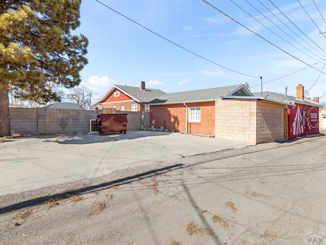 view of front of home featuring fence