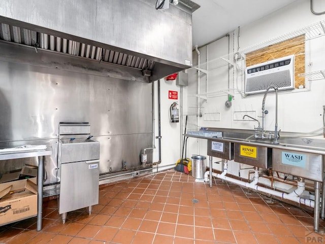 kitchen featuring an AC wall unit and tile patterned floors