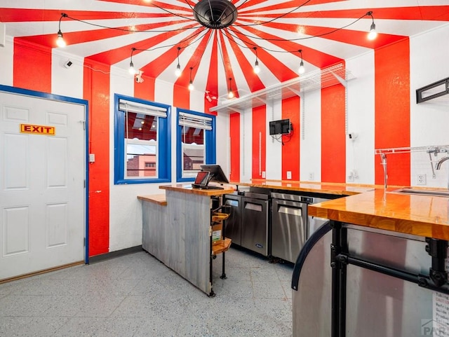 kitchen with speckled floor and a sink