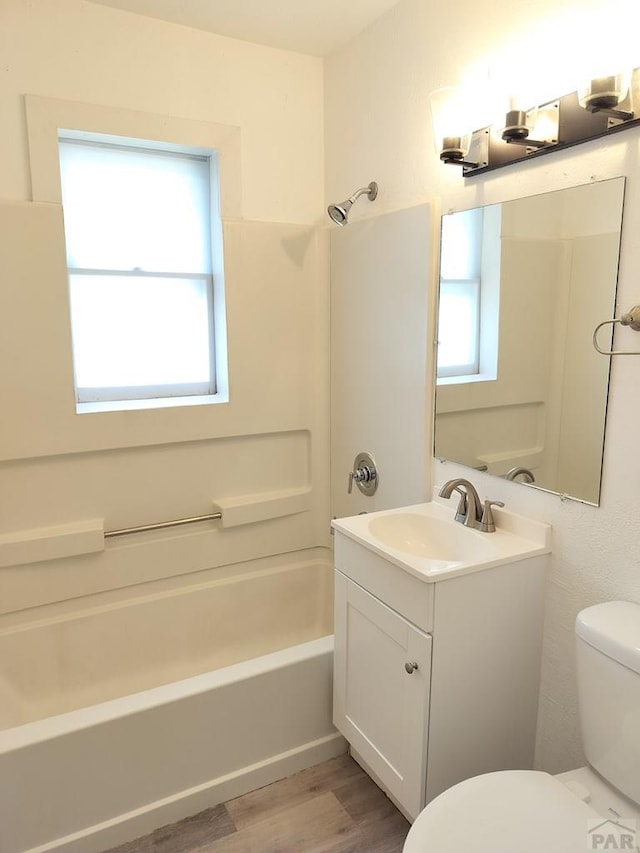 1143 25th Ln, Pueblo, CO 81006 - full bath with vanity, toilet, healthy amount of natural light, and shower / tub combination