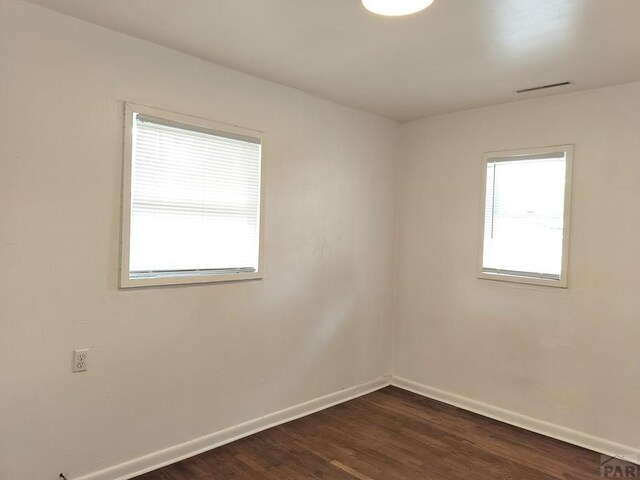 1143 25th Ln, Pueblo, CO 81006 - empty room featuring baseboards and dark wood finished floors