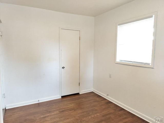 1143 25th Ln, Pueblo, CO 81006 - spare room with dark wood-style floors and baseboards