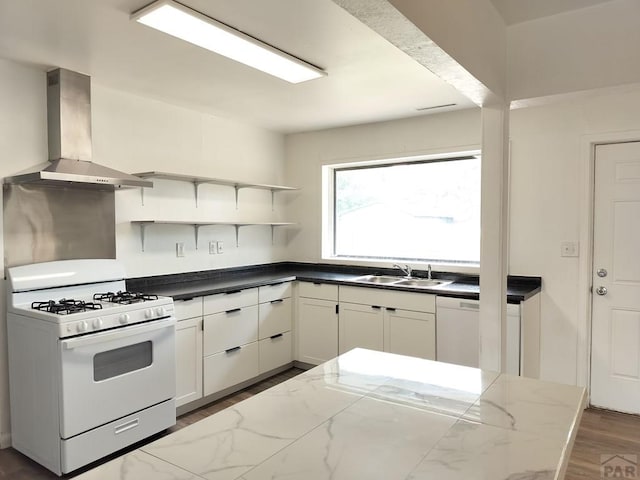1143 25th Ln, Pueblo, CO 81006 - kitchen featuring white appliances, ventilation hood, a sink, open shelves, and dark stone counters