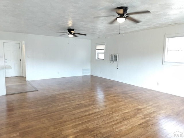 1143 25th Ln, Pueblo, CO 81006 - spare room with ceiling fan, wood finished floors, and a wall unit AC