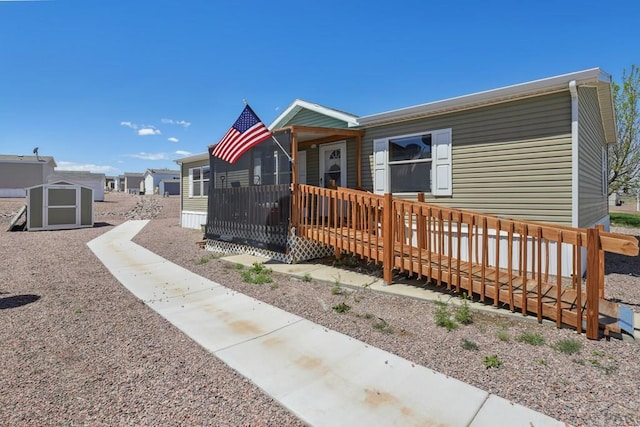 view of front of home featuring a shed and a deck