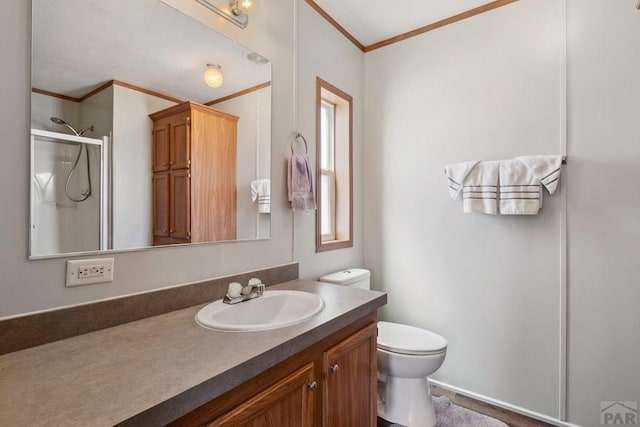 bathroom featuring ornamental molding, toilet, vanity, and a shower stall