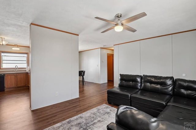 living room with ceiling fan, dark wood-type flooring, and crown molding