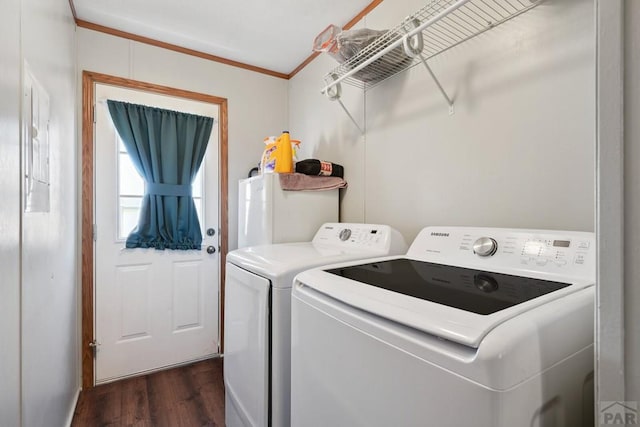 laundry room featuring laundry area, crown molding, dark wood-type flooring, and washer and dryer