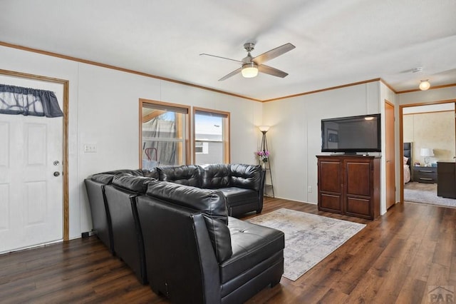 living area with dark wood-style floors, ceiling fan, and crown molding