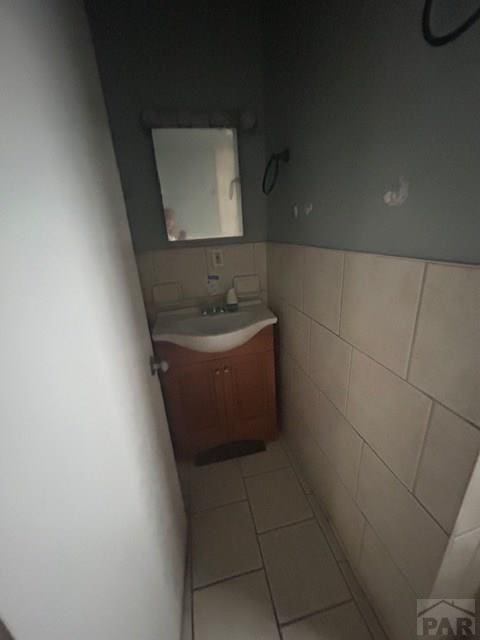 1045 Berkley Ave, Pueblo, CO 81004 - bathroom with vanity, tile walls, and tile patterned flooring
