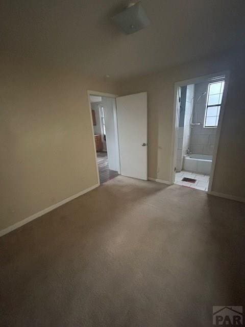 1045 Berkley Ave, Pueblo, CO 81004 - unfurnished bedroom featuring connected bathroom and light colored carpet