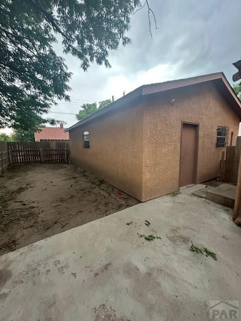 1045 Berkley Ave, Pueblo, CO 81004 - view of home's exterior featuring stucco siding and a patio area