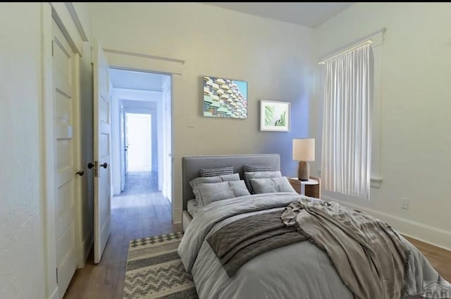 bedroom with wood finished floors and baseboards