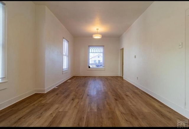 interior space featuring baseboards and wood finished floors